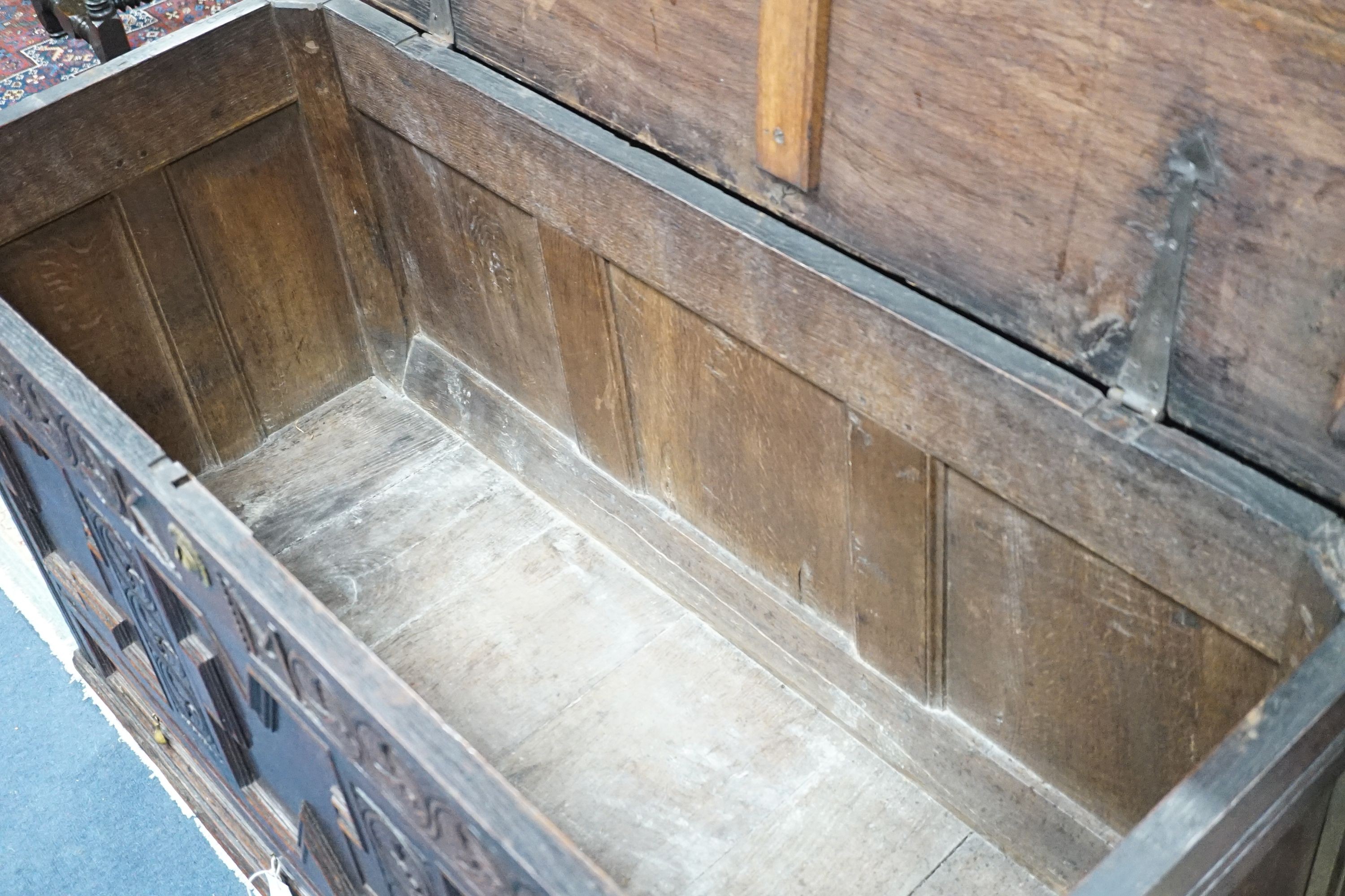 A William and Mary carved oak mule chest with K M initialled frieze and triple panelled front, length 132cm, depth 51cm, height 78cm